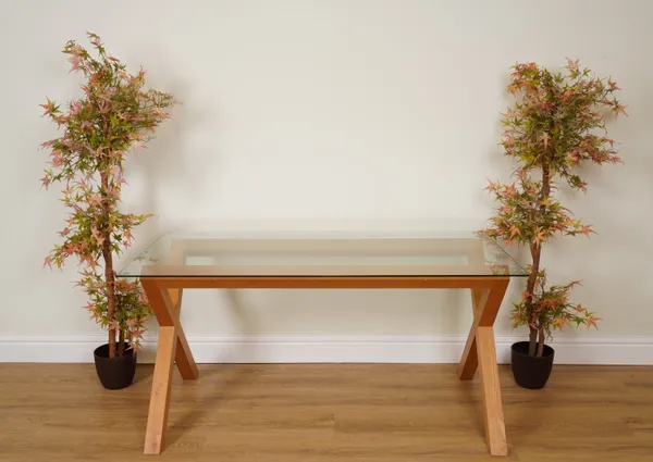 A RECTANGULAR GLASS DINING TABLE