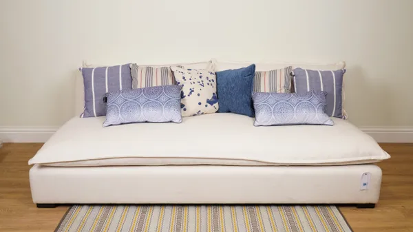 CUSHIONS, A GROUP OF EIGHT CUSHIONS IN BLUE FABRICS (8)