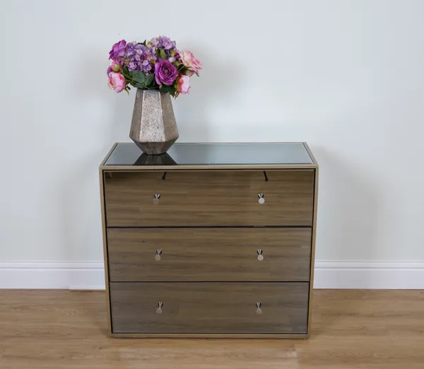 A MIRRORED CHEST OF DRAWERS