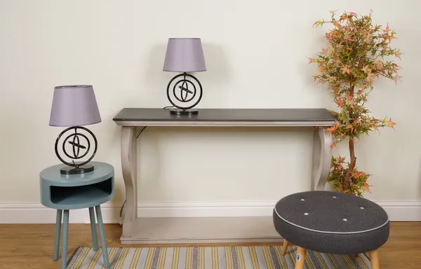 LIGHTING, A PAIR OF BLACK METAL TABLE LAMPS FORMED AS CIRCLES WITH TAPERING GREY SHADES