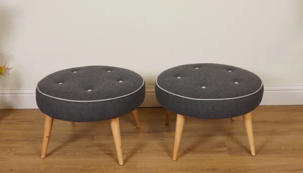 A PAIR OF GREY UPHOLSTERED CIRCULAR FOOTSTOOLS (2)