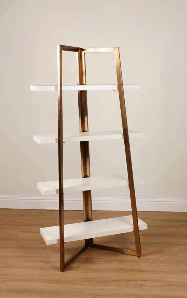 A WHITE LACQUER AND BRASS COLOURED METAL FOUR TIER BOOKCASE