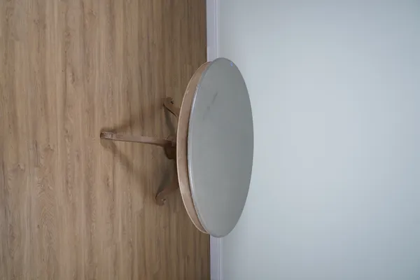 A GREEN PAINTED CIRCULAR DINING TABLE