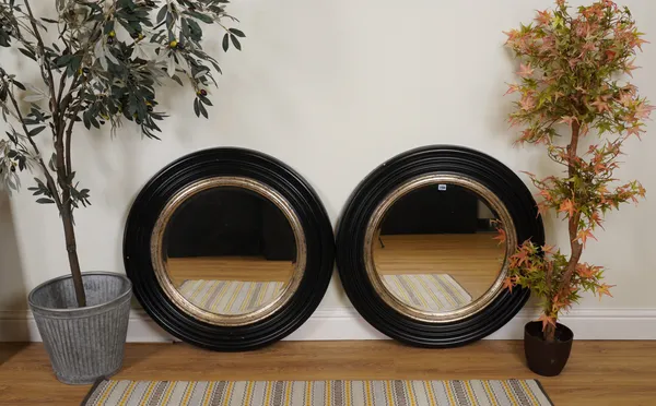 A PAIR OF BLACK PAINTED CIRCULAR WALL MIRROS (2)