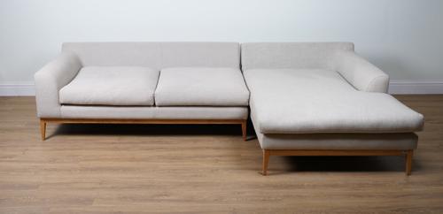 A LARGE BEIGE CORNER SOFA