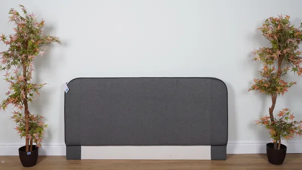 A DARK GREY UPHOLSTERED DOUBLE HEADBOARD