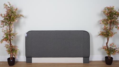 A DARK GREY UPHOLSTERED DOUBLE HEADBOARD