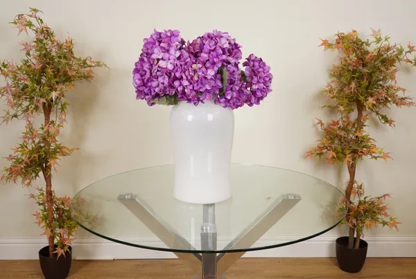 A LARGE BOUQUET OF FAUX PURPLE HYDRANGEAS