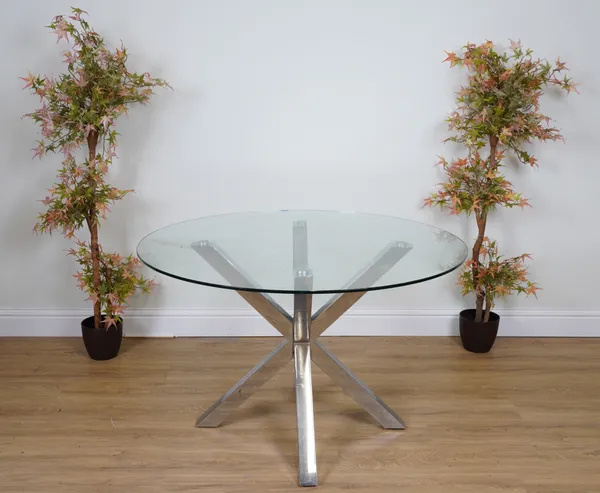 A GLASS CIRCULAR DINING TABLE