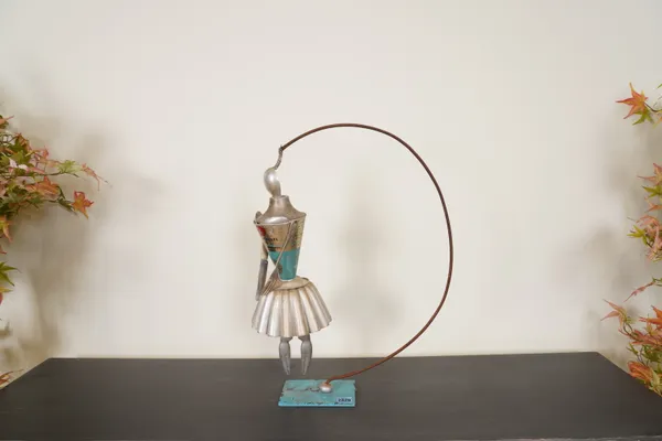 A MID 20TH CENTURY ABSTRACT FIGURE FORMED FROM KITCHEN UTENSILS