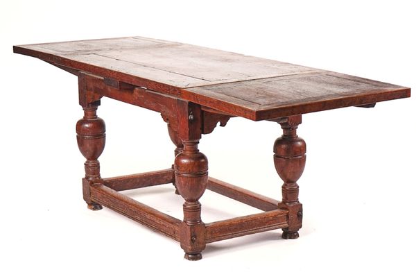 A 17TH CENTURY STYLE OAK DRAW LEAF EXTENDING DINING TABLE