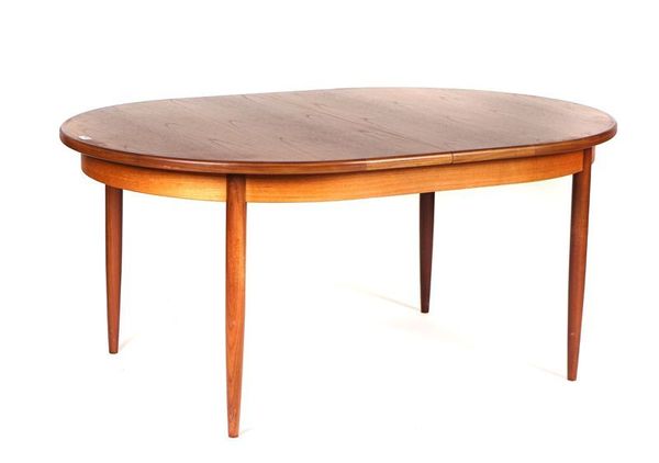 G-PLAN; A TEAK OVAL EXTENDING DINING TABLE