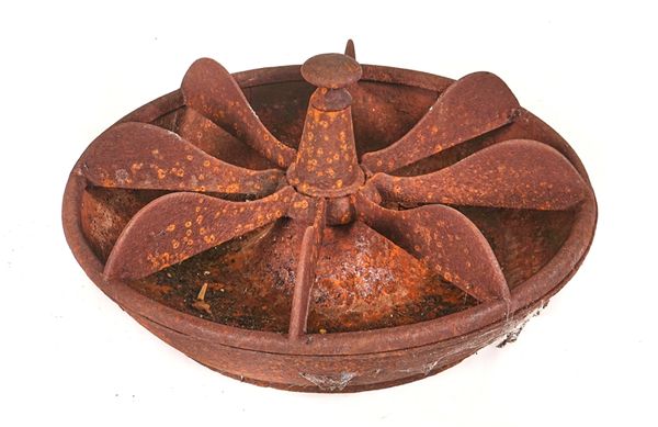 A LARGE CAST IRON ‘MEXICAN HAT’ PIG FEEDER