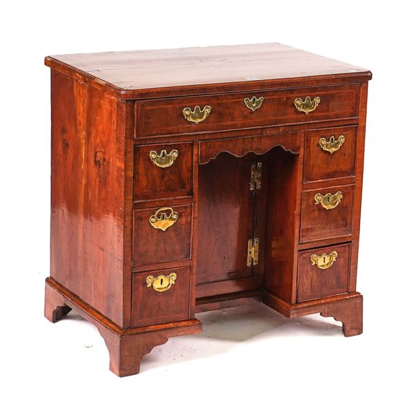 A GEORGE II WALNUT KNEEHOLE WRITING DESK