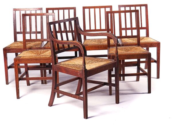 IN THE MANNER OF HEALS; A SET OF SEVEN OAK FRAMED STICK BACK CHAIRS (7)