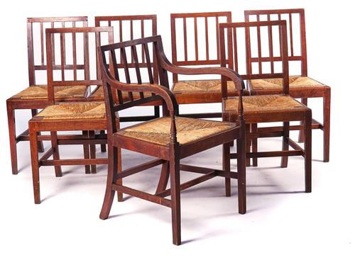 IN THE MANNER OF HEALS; A SET OF SEVEN OAK FRAMED STICK BACK CHAIRS (7)