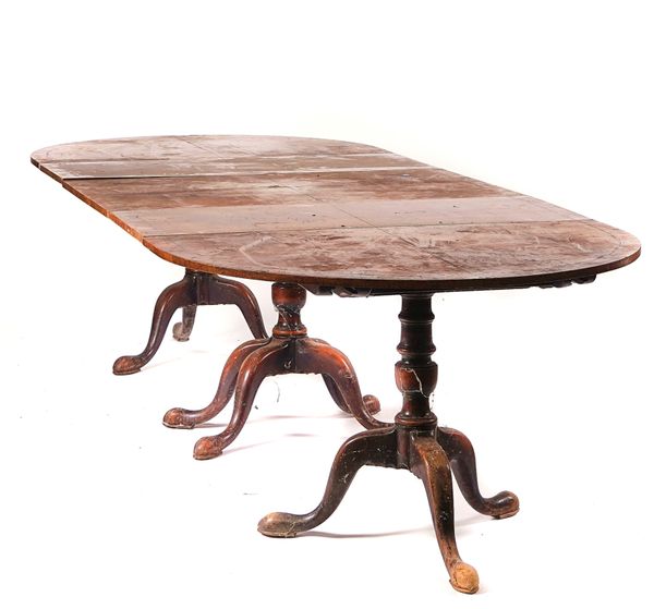 A GEORGE III AND LATER WALNUT TRIPLE PILLAR EXTENDING DINING TABLE