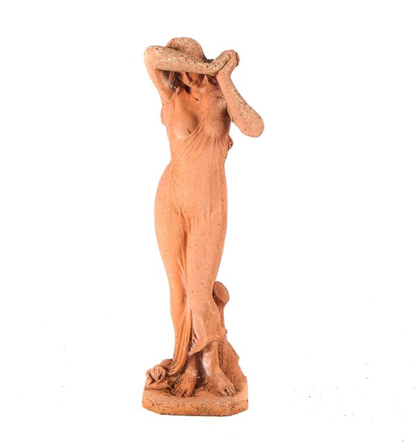 A RECONSTITUTED STONE FIGURE OF A SCANTILY CLAD FEMALE
