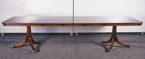 A GEORGE III STYLE MAHOGANY EXTENDING DINING TABLE