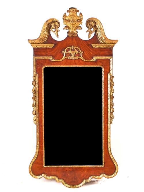 A GEORGE II PARCEL-GILT AND WALNUT MIRROR