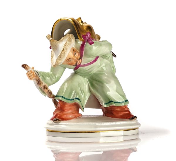 A MEISSEN FIGURE OF A CHINAMAN WITH MASK
