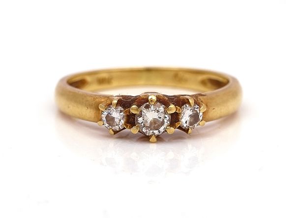 A GOLD AND DIAMOND THREE STONE RING