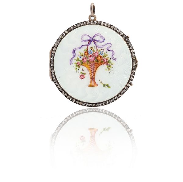 AN ENAMELLED AND COLOURLESS PASTE CIRCULAR PENDANT LOCKET
