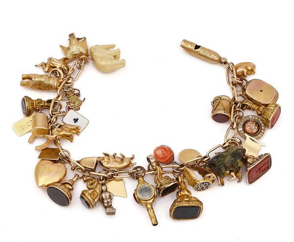 A GOLD BRACELET, FITTED WITH THIRTY-SIX PENDANTS AND CHARMS