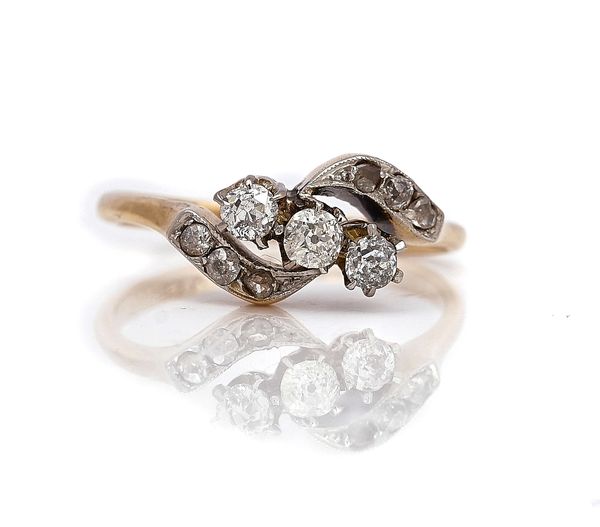 A GOLD AND PLATINUM, DIAMOND CROSSOVER RING