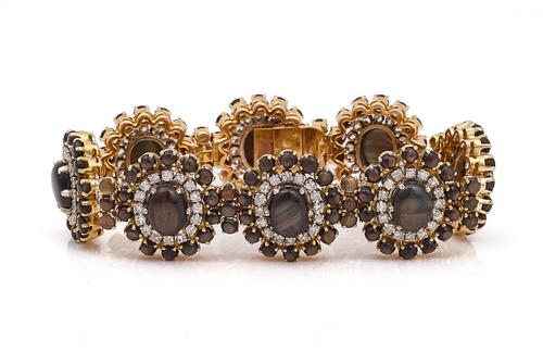 A GOLD, CABOCHON BLACK SAPPHIRE AND DIAMOND BRACELET
