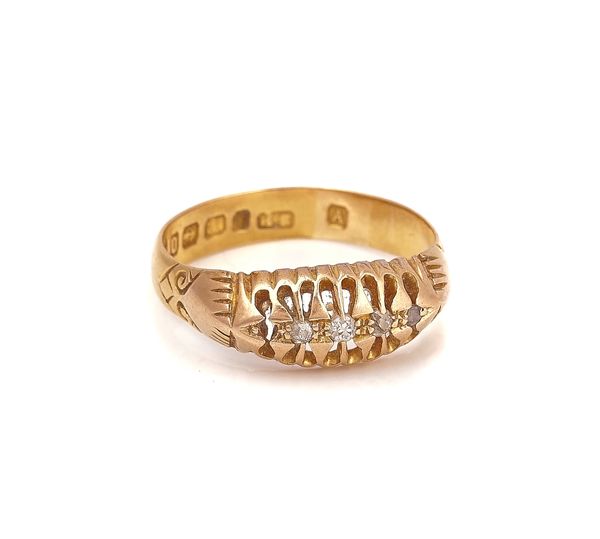 A GOLD RING MOUNTED WITH A ROW OF FOUR  SMALL GRADUATED DIAMONDS