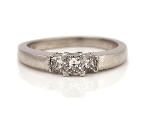 A PLATINUM AND DIAMOND THREE STONE RING