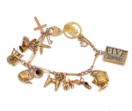 A 9CT GOLD CHARM BRACELET