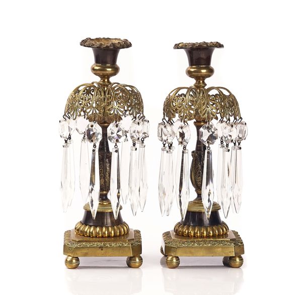A PAIR OF REGENCY BRASS AND BRONZE PATINATED LUSTRE CANDLESTICKS (2)