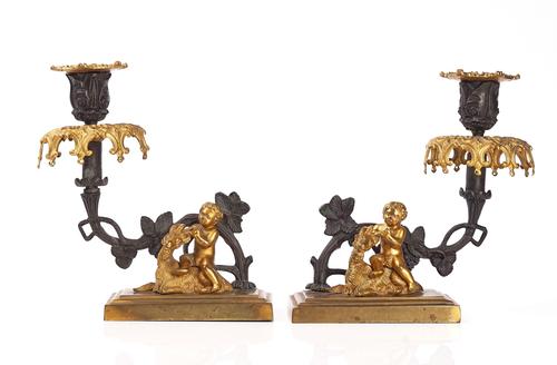 A PAIR OF EARLY VICTORIAN PARCEL-GILT AND BRONZE PATINATED CANDLESTICKS