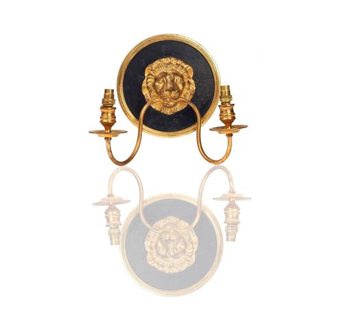 A SET OF FOUR FRENCH GILT AND BLACK PAINTED METAL TWIN-LIGHT WALL APPLIQUÉS