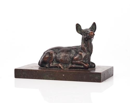 A BRONZE FIGURE OF A RECUMBENT DEER