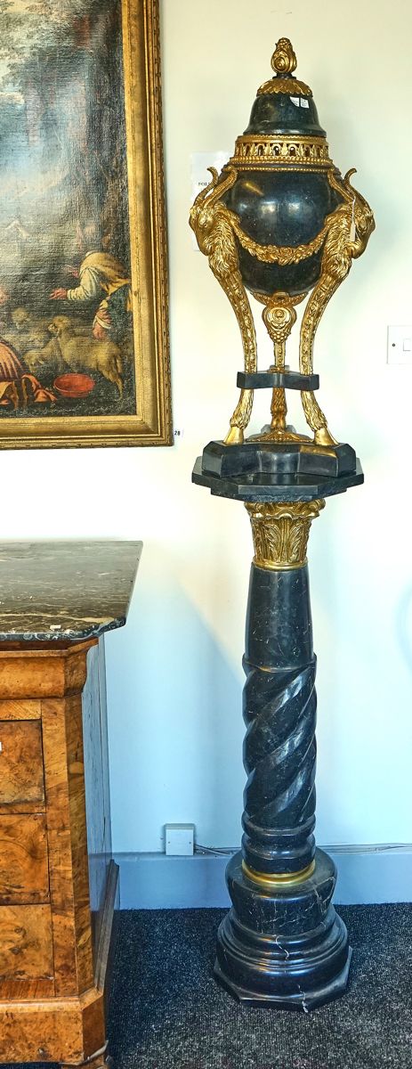 A PAIR OF LOUIS XV STYLE GILT DECORATED MARBLE VENEERED COMPOSITE URNS ON STANDS