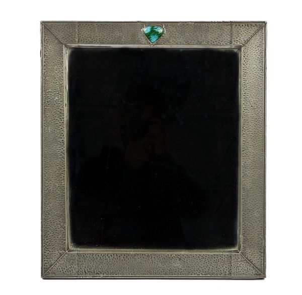 IN THE MANNER OF LIBERTY’S; A BEATEN PEWTER AND SEMI-PRECIOUS STONE INSET STRUT MIRROR