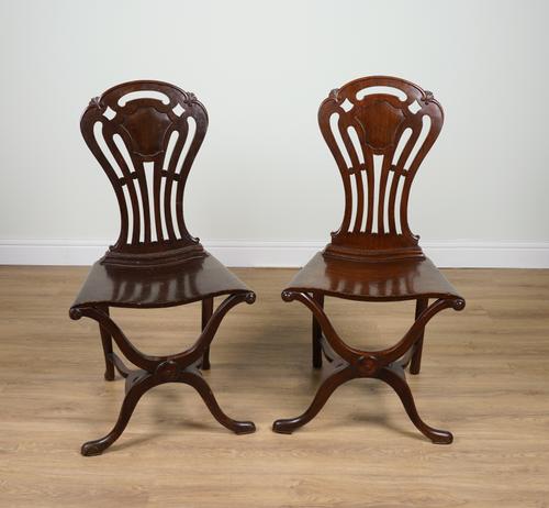 A MATCHED PAIR OF MAHOGANY PIERCED BACK HALL CHAIRS (2)