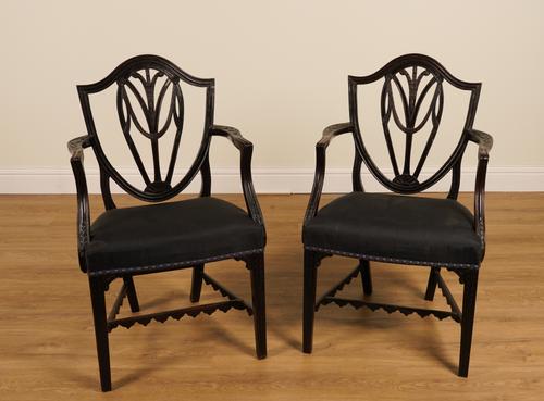 A PAIR OF GEORGE III CARVED MAHOGANY SHIELD BACK OPEN ARMCHAIRS (2)