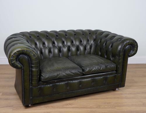 A STUDDED GREEN LEATHER UPHOLSTERED TWO-SEAT CHESTERFIELD SOFA
