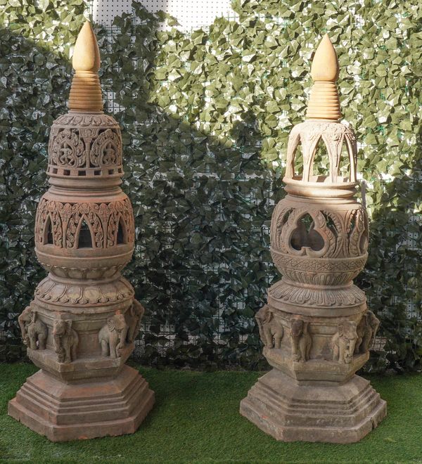 A PAIR OF TERRACOTTA LANTERNS WITH TURNED FINIALS AND OPPOSING ELEPHANT BASES (2)