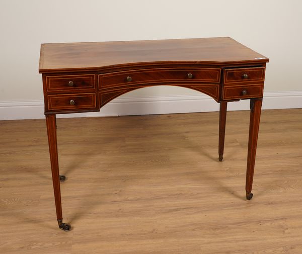 A GEORGE III LINE INLAID MAHOGANY CONCAVE FOUR DRAWER WRITING DESK