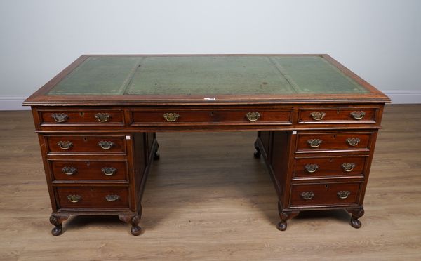 A MAHOGANY NINE DRAWER PEDESTAL DESK