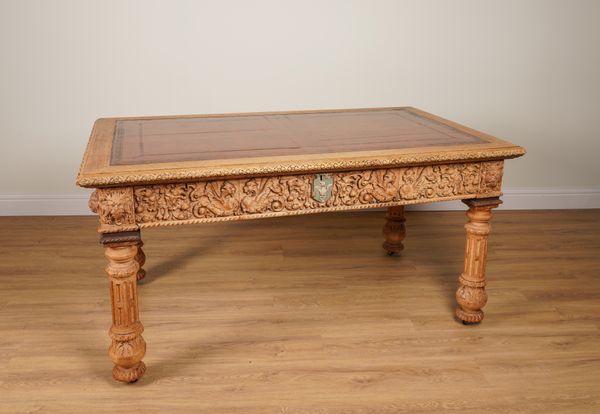 A VICTORIAN BLEACHED AND CARVED OAK THREE DRAWER CENTRE LIBRARY TABLE