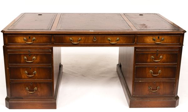 A MAHOGANY PEDESTAL DESK WITH NINE DRAWERS ABOUT THE KNEE