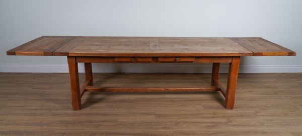 AN OAK CLEATED PLANK TOP EXTENDING DINING TABLE