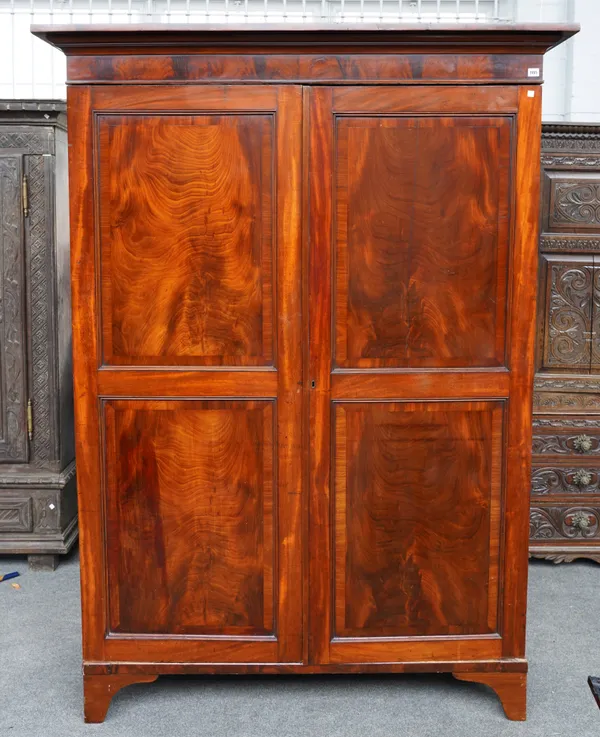 POSSIBLY CHANNEL ISLANDS; AN 18TH CENTURY MAHOGANY KNOCK DOWN TWO DOOR WARDROBE