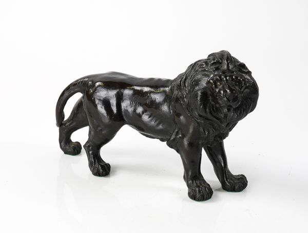 A JAPANESE BRONZE MODEL OF A STANDING LION